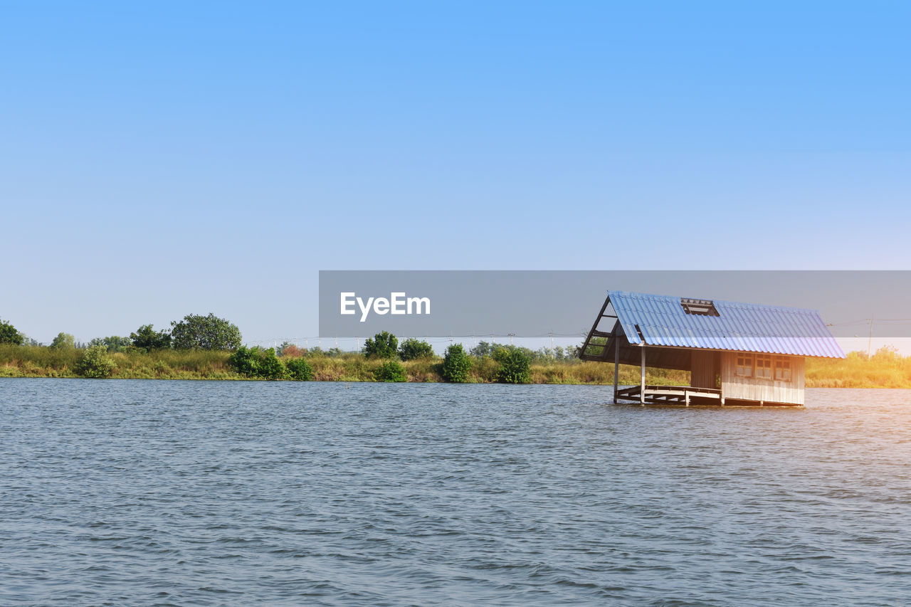 STILT HOUSE AGAINST CLEAR BLUE SKY