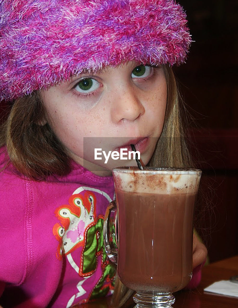 Portrait of girl sipping hot chocolate drink