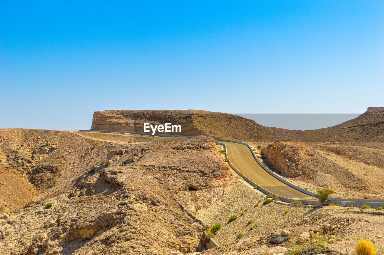 Scenic view of mountains against clear blue sky