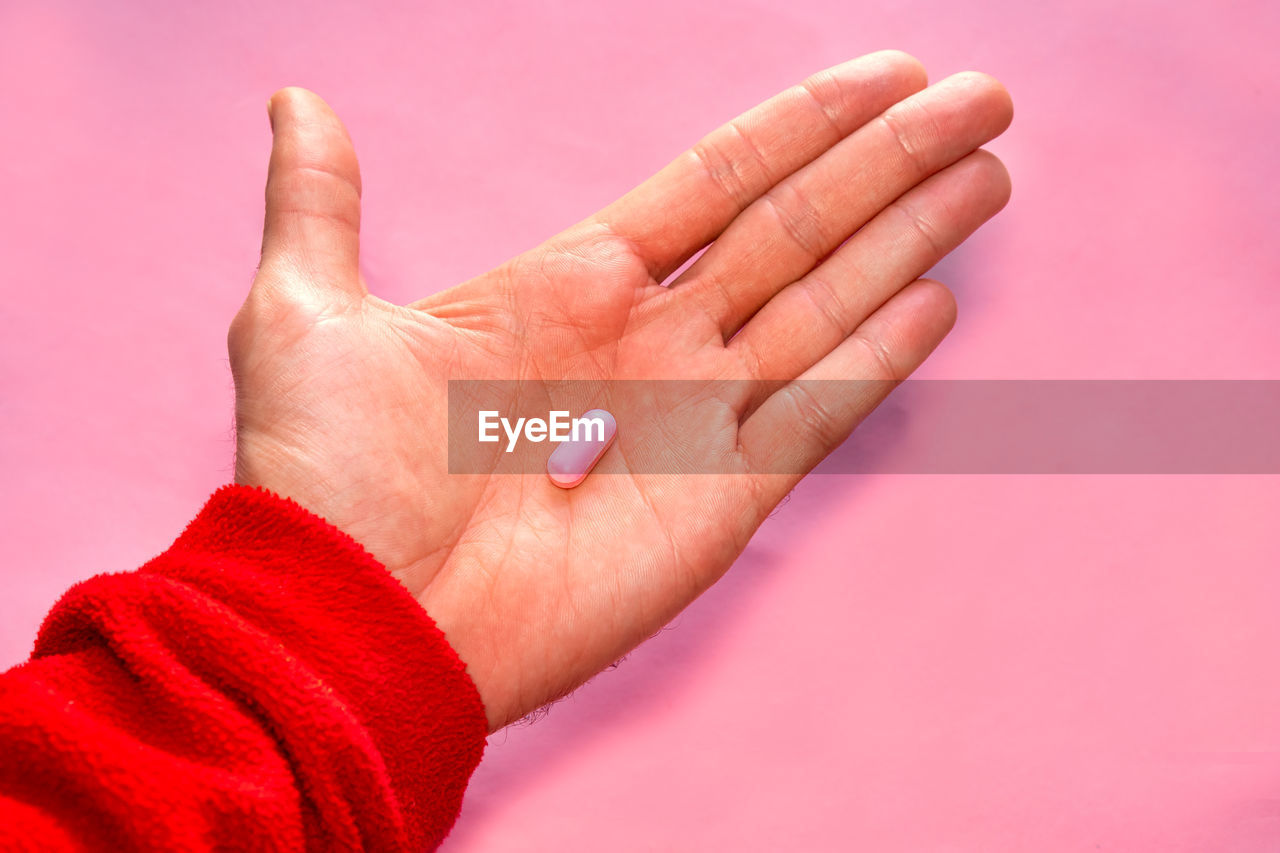 cropped image of person gesturing against blue background