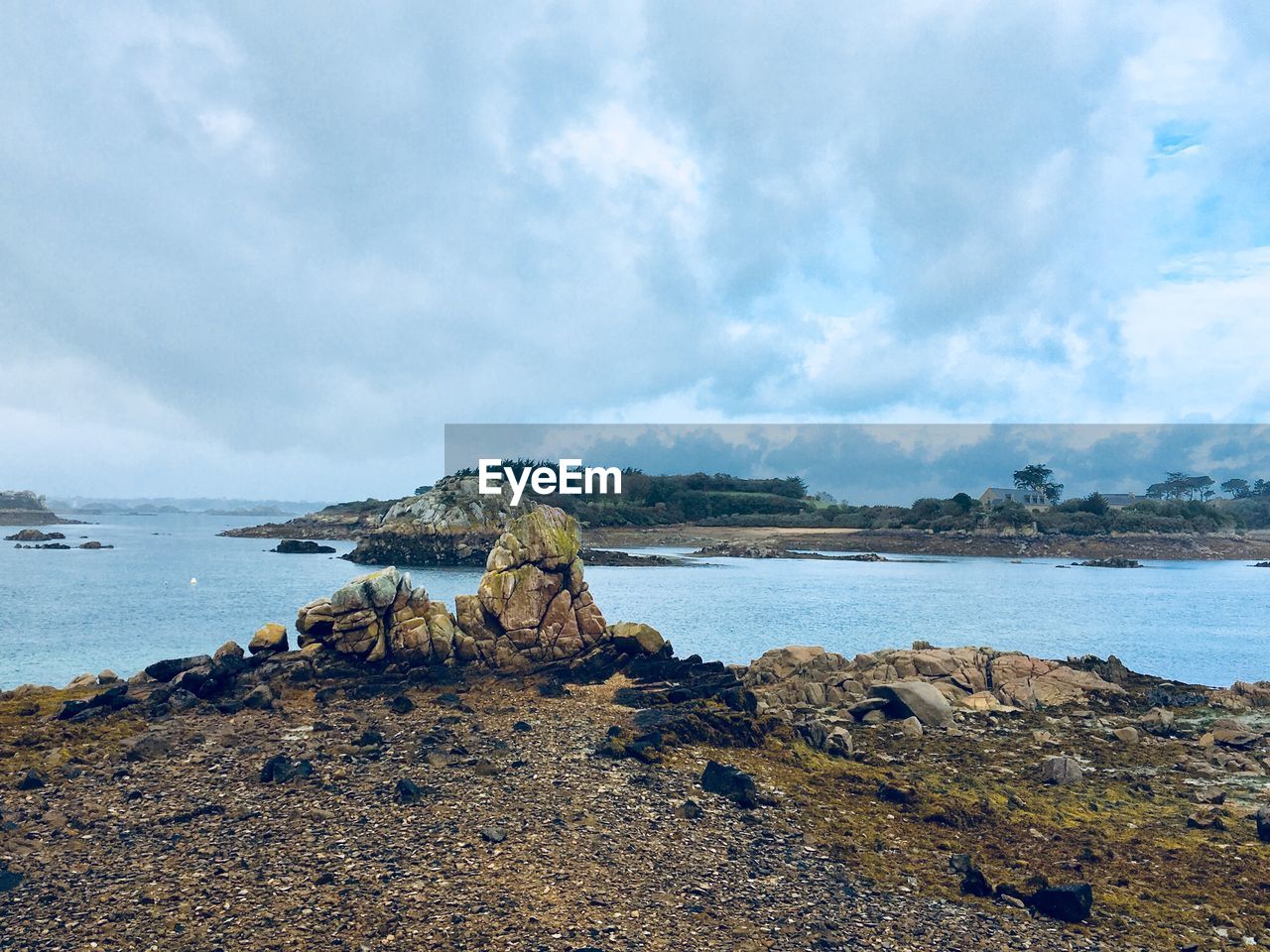 Scenic view of rocks on beach against sky