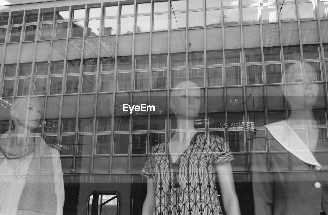 WOMAN LOOKING THROUGH WINDOW