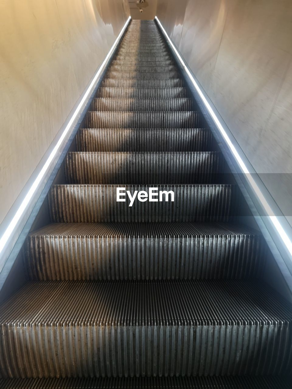 escalator, convenience, the way forward, technology, architecture, indoors, staircase, futuristic, metal, steps and staircases, transportation, railing, no people, illuminated, built structure, stairs, diminishing perspective, line, motion