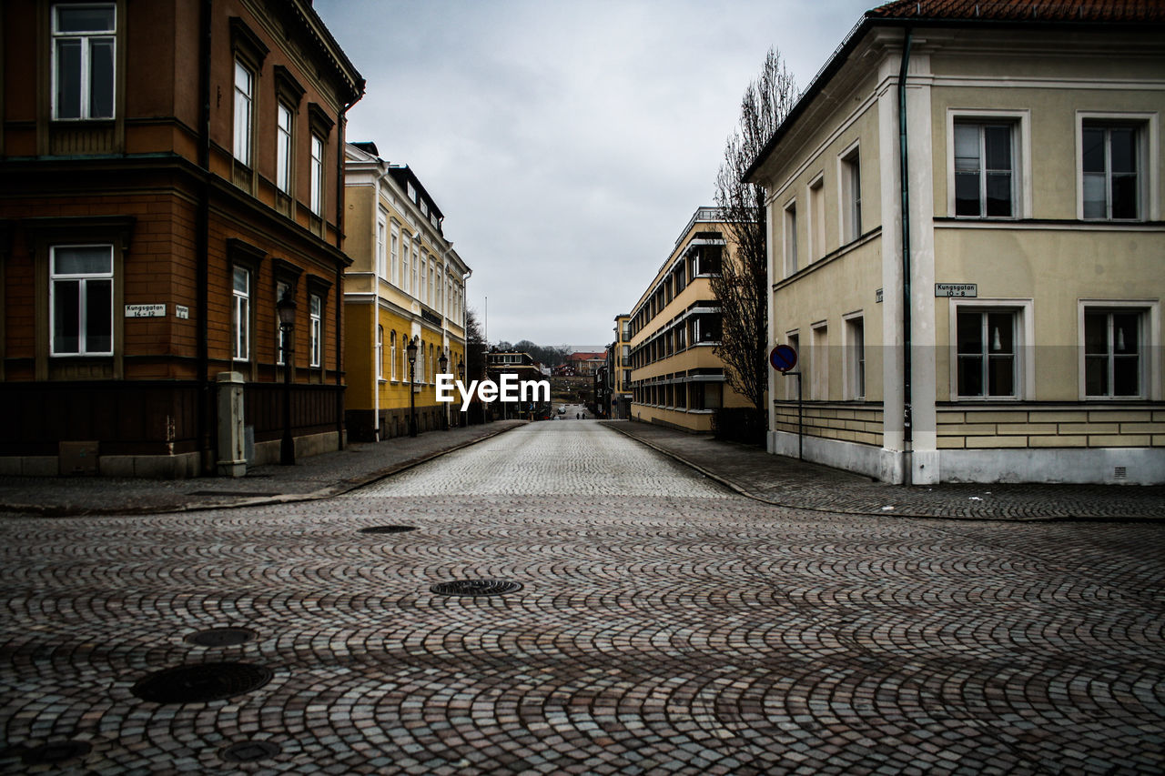 Street amidst buildings against sky