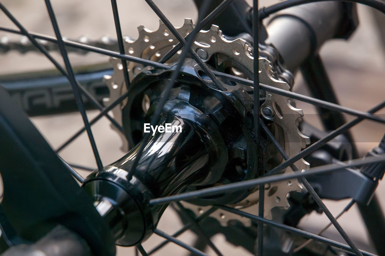 CLOSE-UP OF BICYCLE PARKED BY METAL