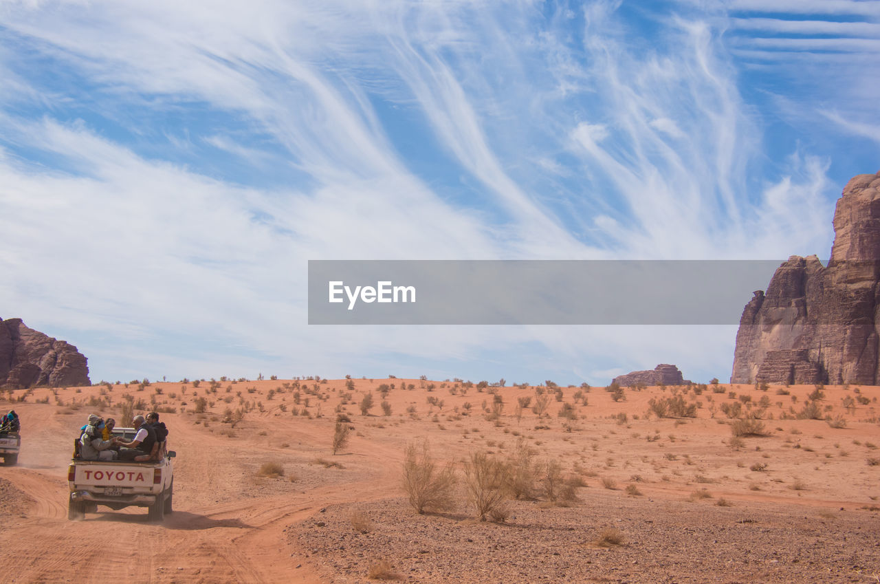 View of desert against cloudy sky