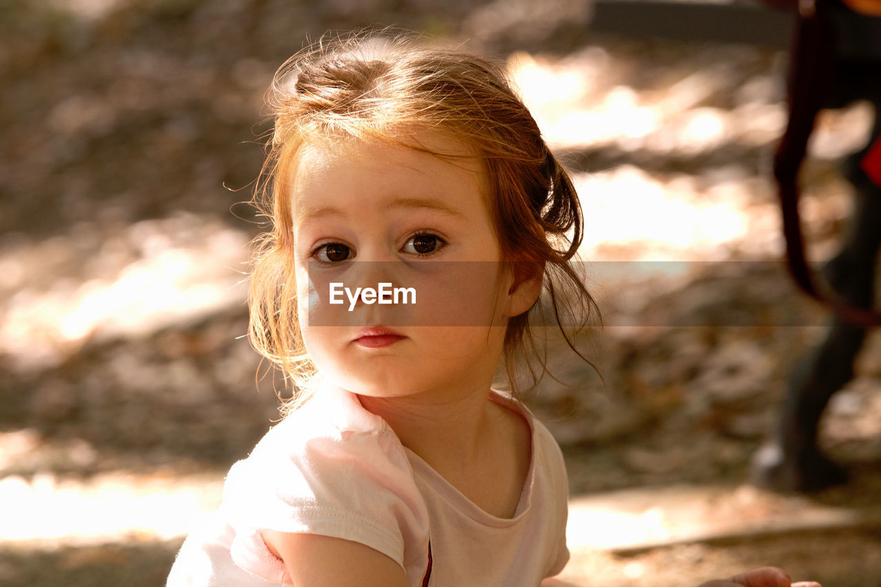 Close-up of cute girl looking away