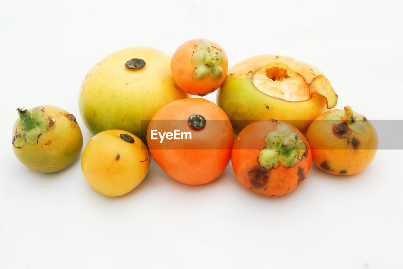 High angle view of persimmons on white background