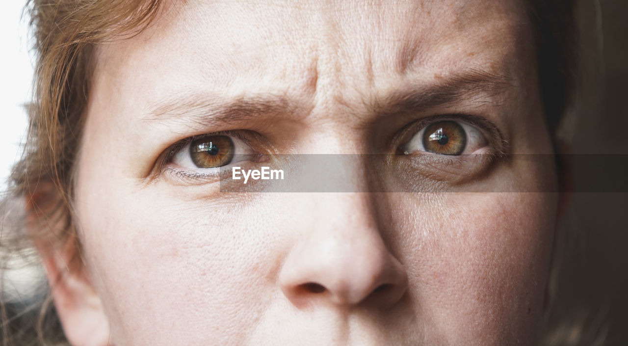 human face, portrait, close-up, portrait photography, one person, skin, headshot, looking at camera, nose, human head, eye, human eye, adult, person, emotion, cheek, freckle, front view, serious, women, eyebrow, young adult, sadness, indoors, men, studio shot