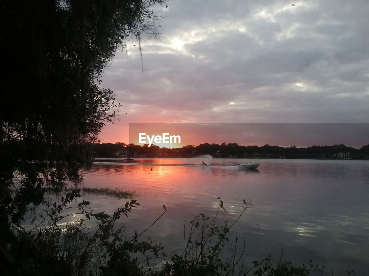 SCENIC VIEW OF LAKE AT SUNSET