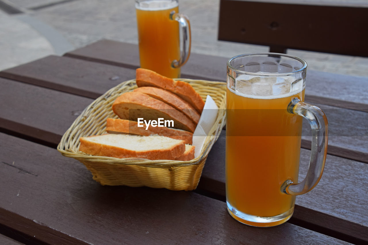 Beer glasses and breads on wooden table