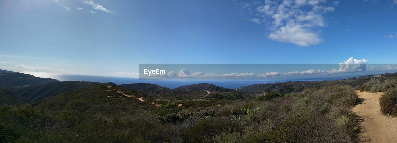 Panoramic shot of landscape against blue sky