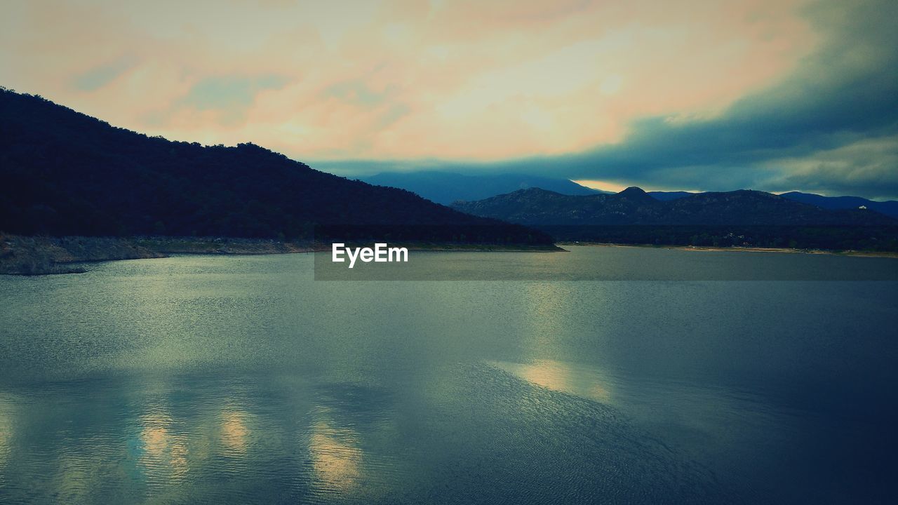 Scenic view of mountains against cloudy sky