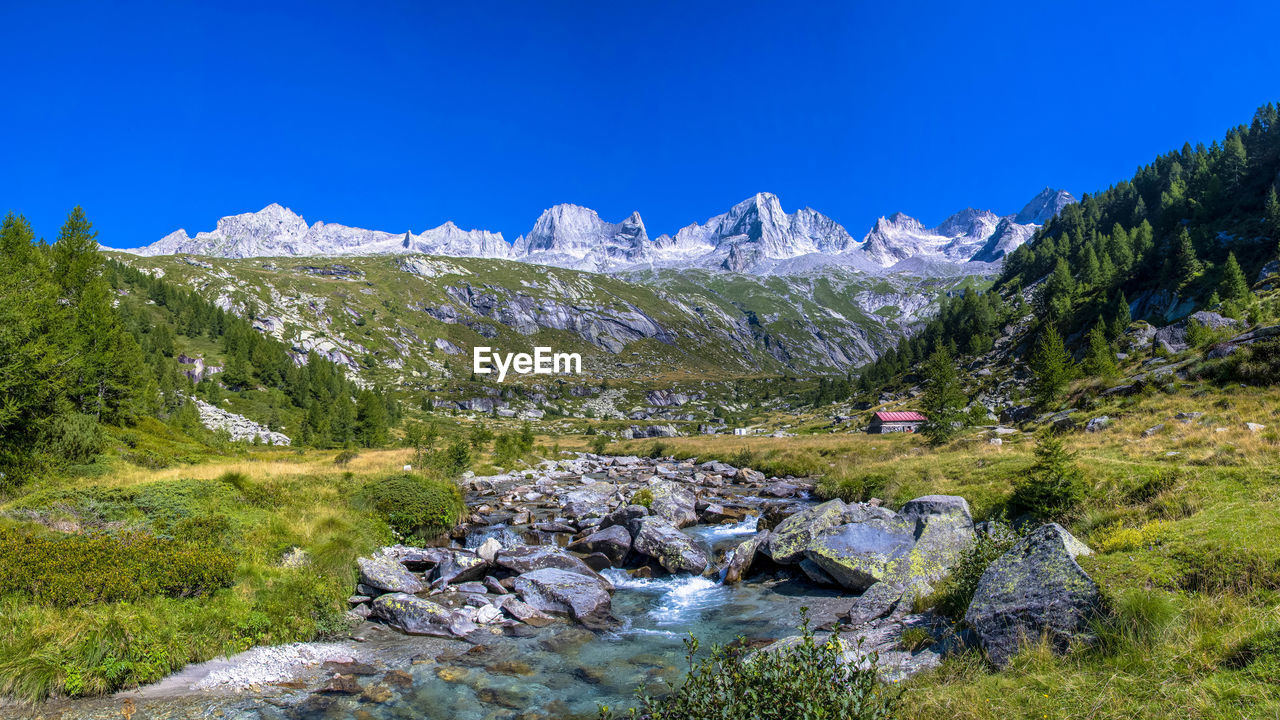 Scenic view of mountain against blue sky