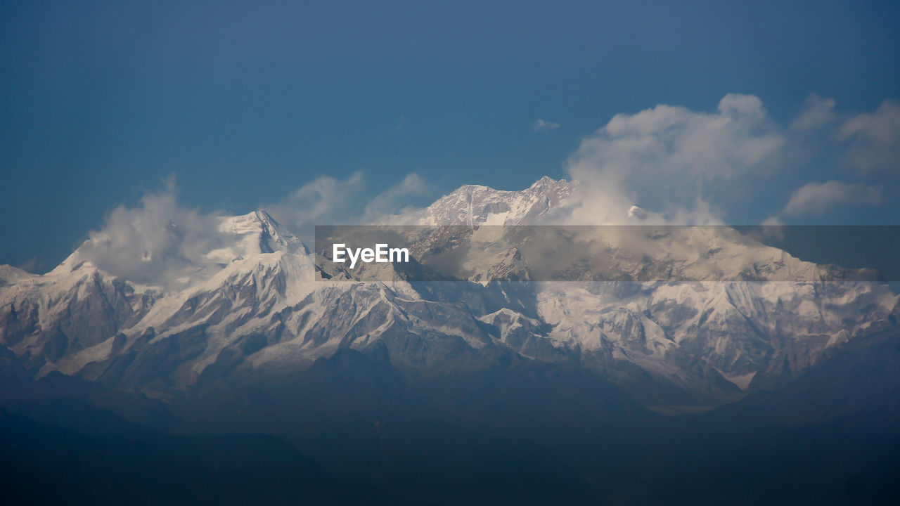 Scenic view of snow mountains against sky