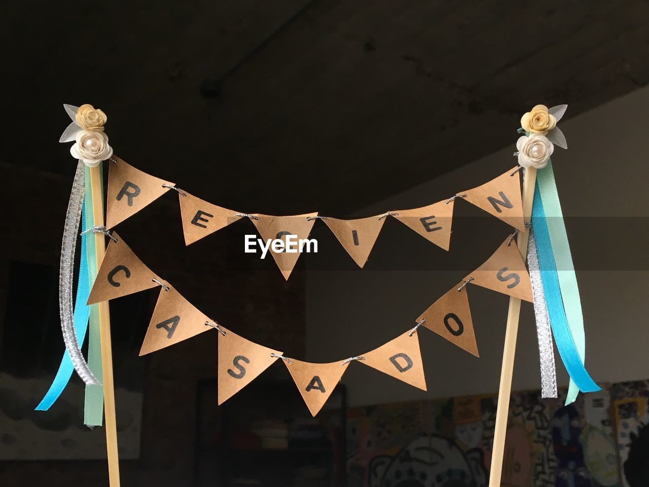 Text over bunting decoration on sticks