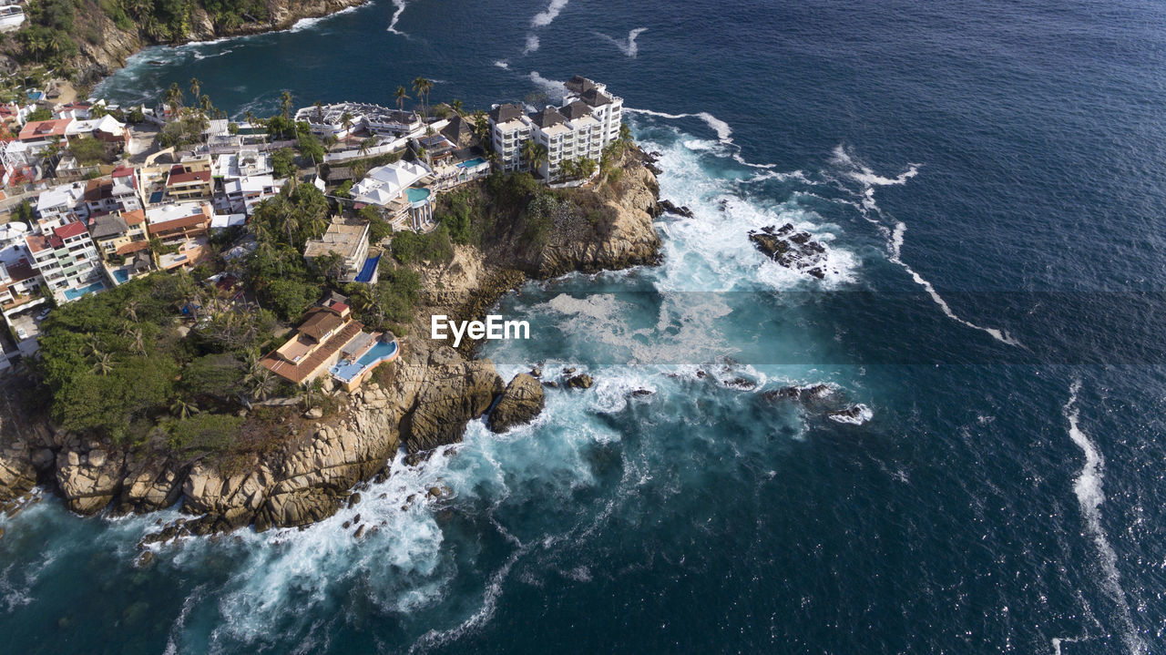 High angle view of buildings by sea