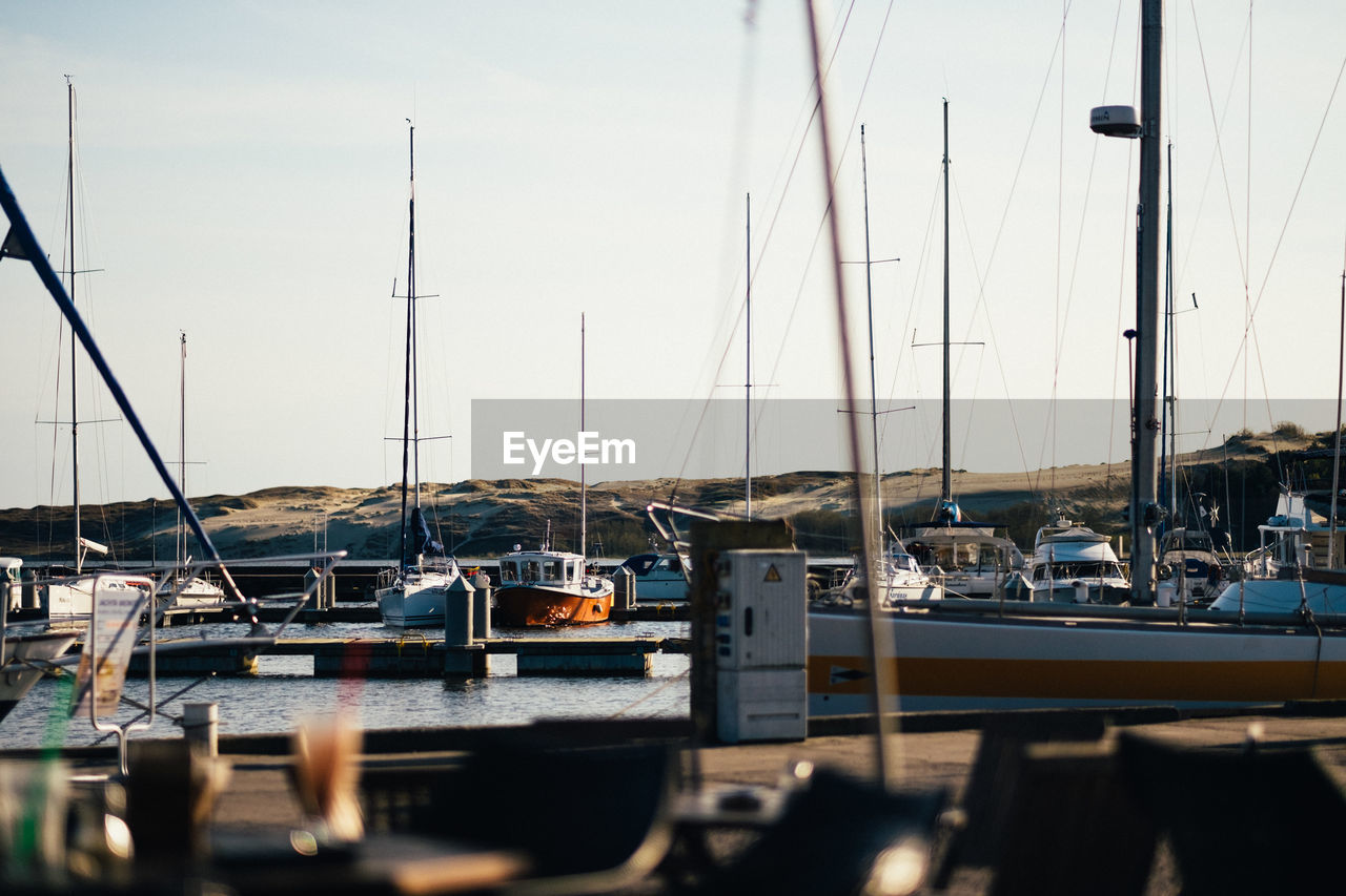 BOATS MOORED AT HARBOR