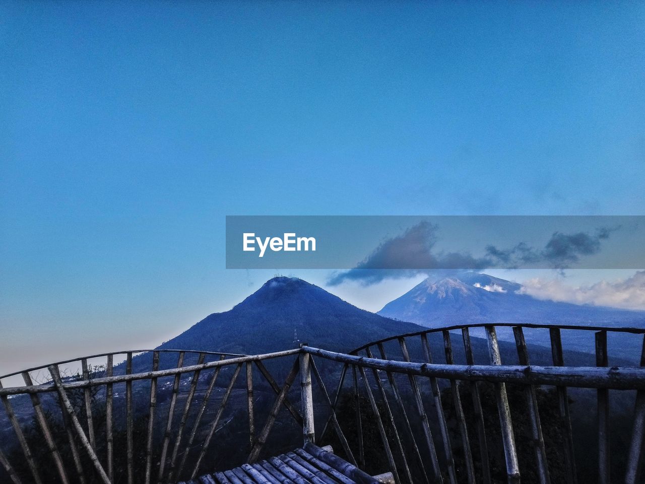 Scenic view of snowcapped mountains against blue sky