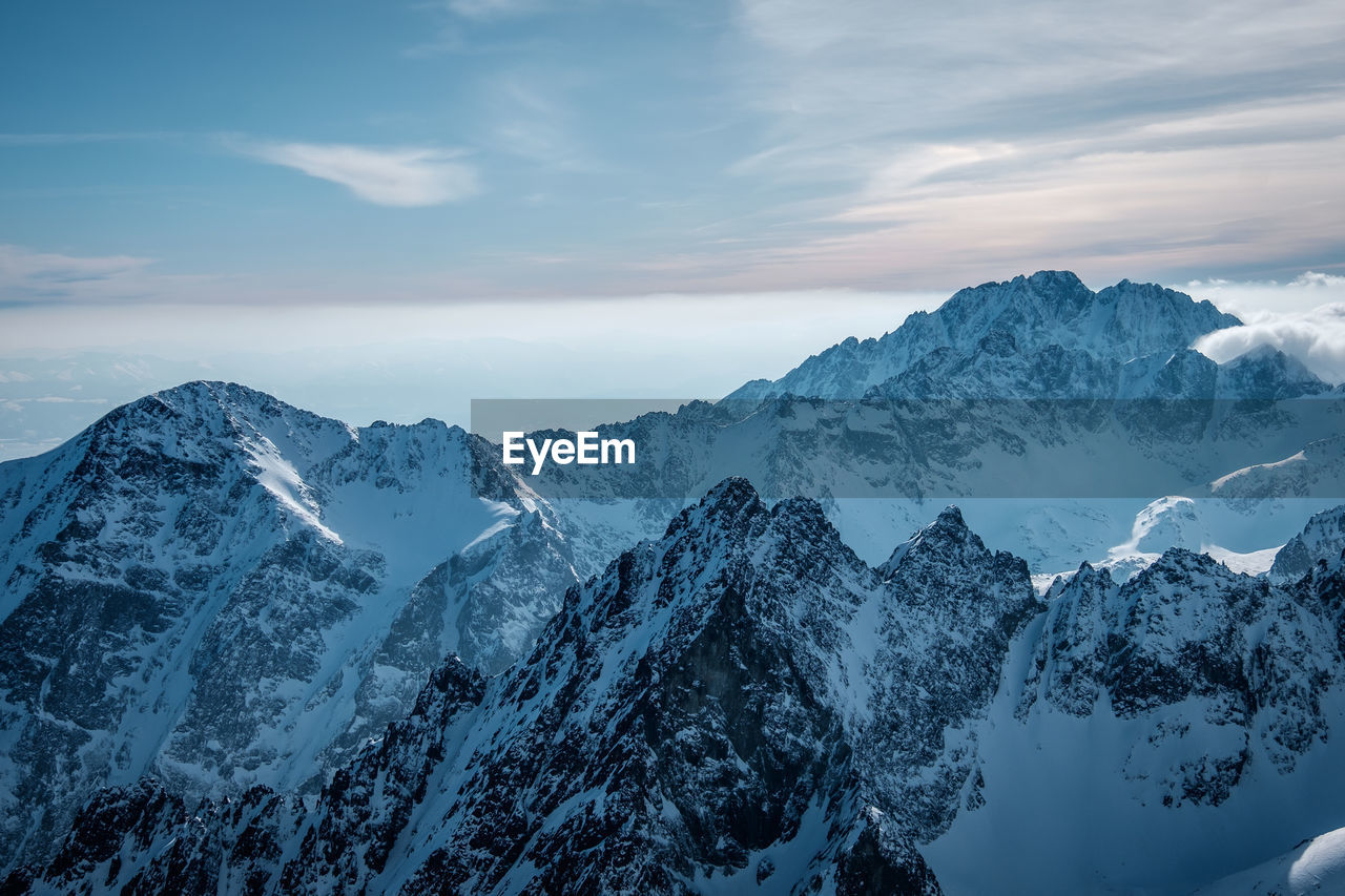 Scenic view of snowcapped mountains against sky
