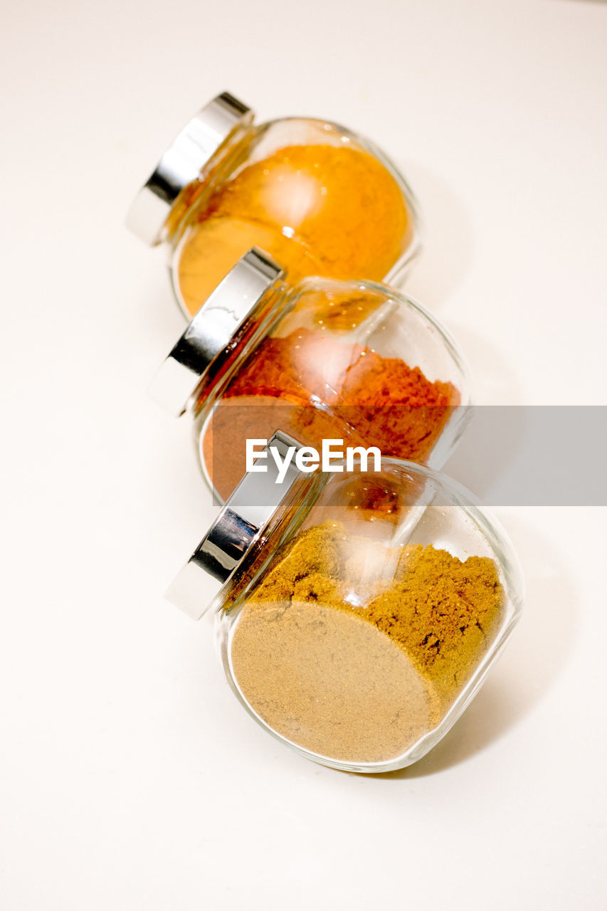 High angle view of spices in jar on white background