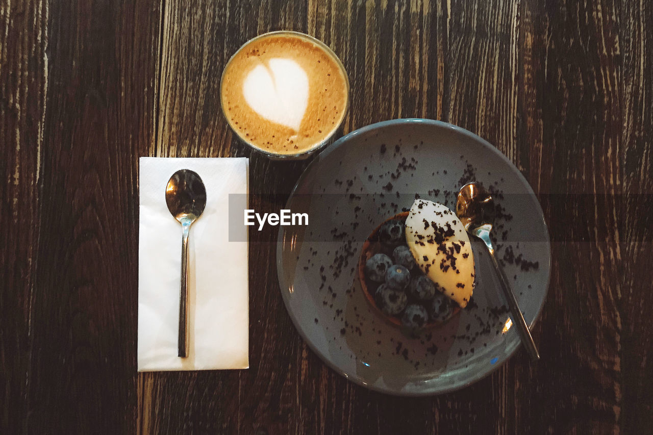 HIGH ANGLE VIEW OF COFFEE ON GLASS TABLE