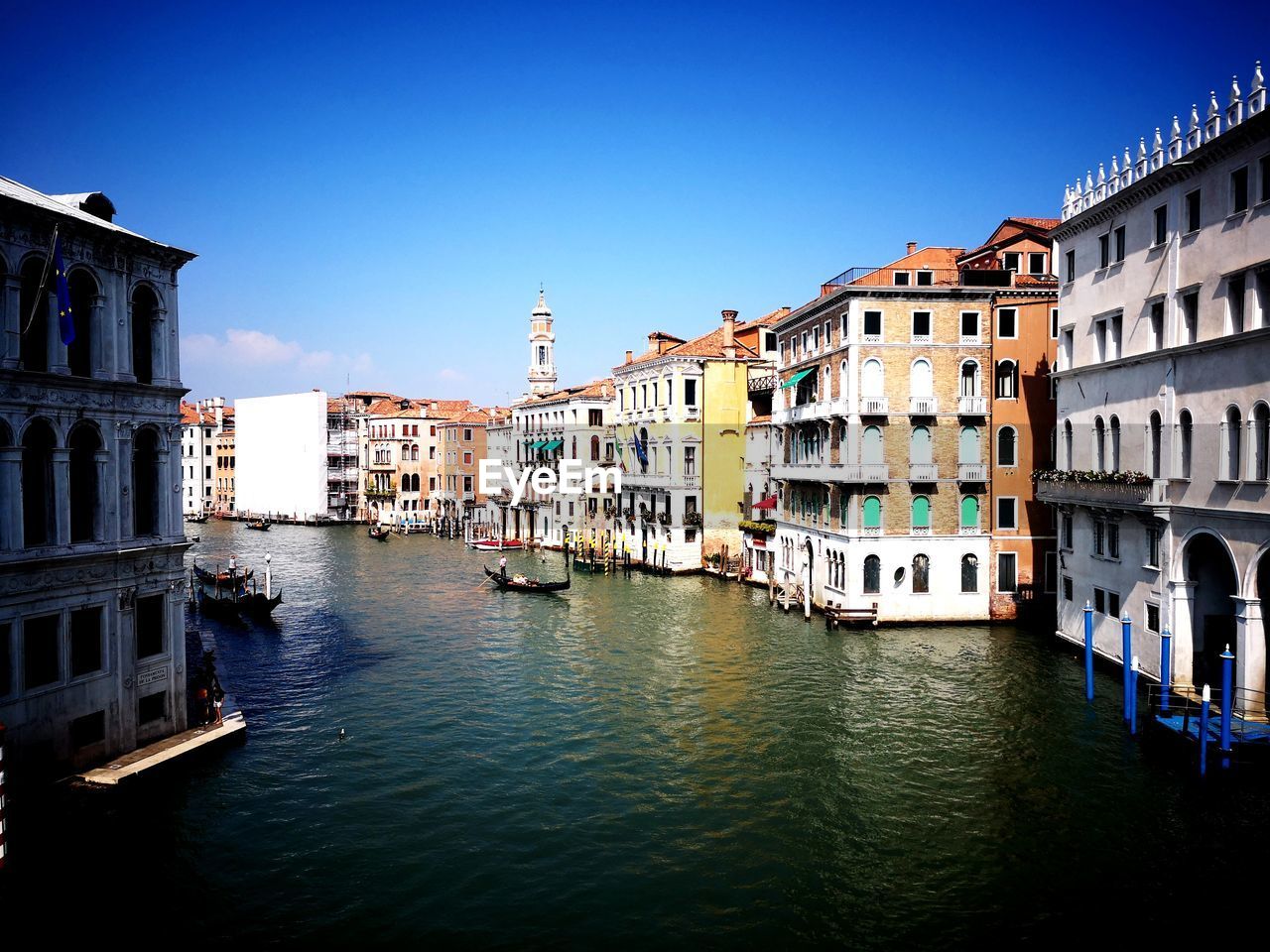 CANAL AMIDST BUILDINGS IN CITY