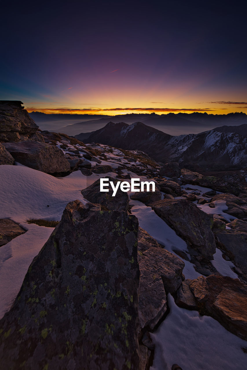 SCENIC VIEW OF MOUNTAIN AGAINST SKY AT SUNSET