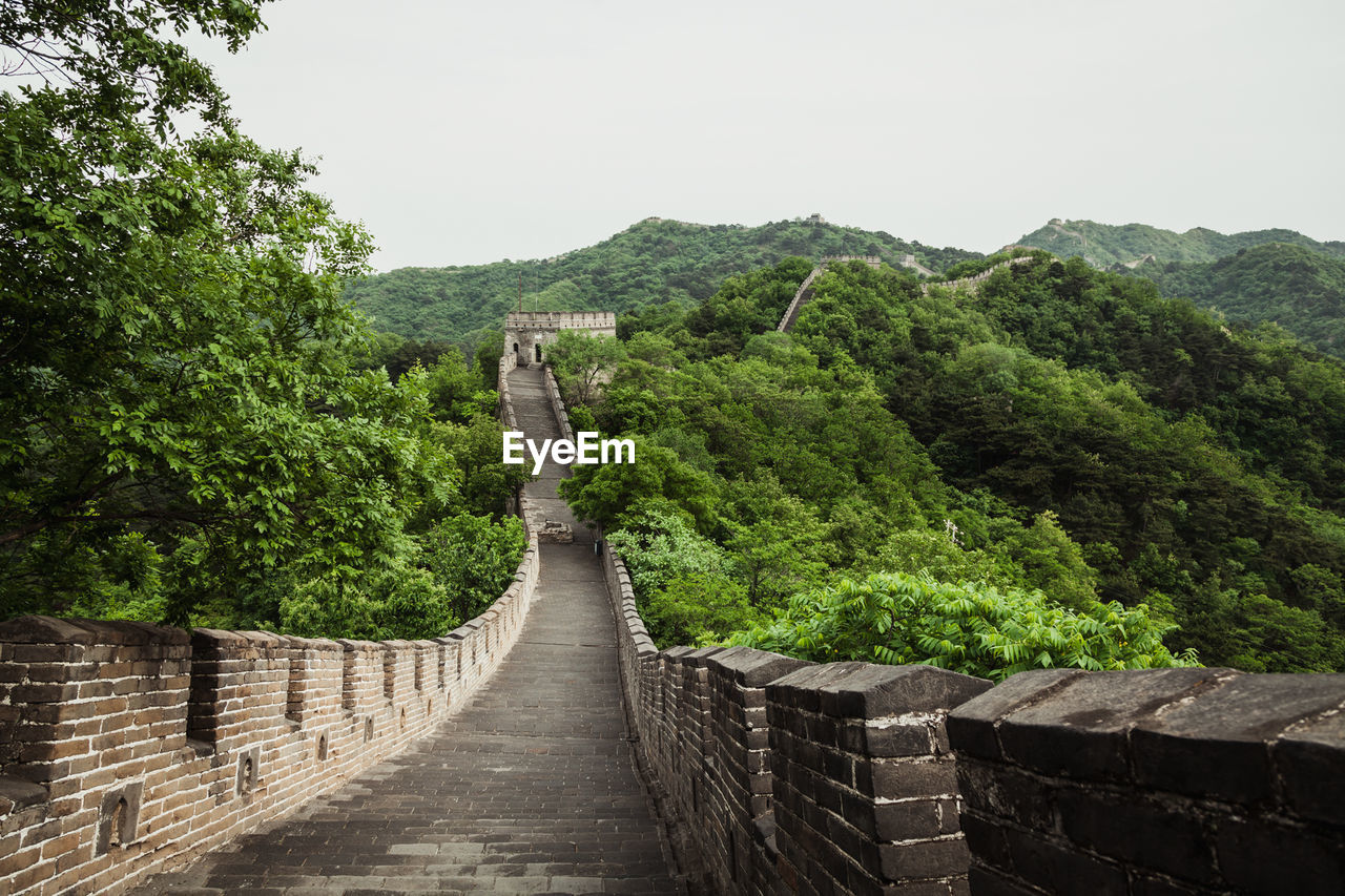 Great wall of china by trees against sky