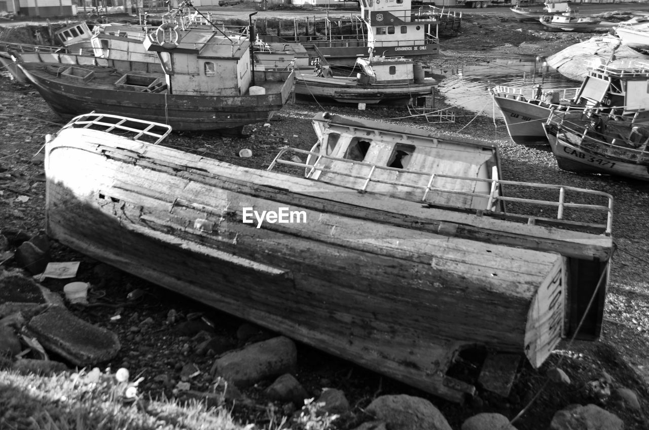 ABANDONED BOATS MOORED AT SHORE