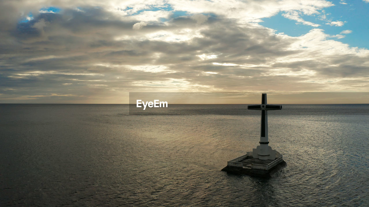 Large crucafix marking the underwater sunken cemetary, camiguin island philippines.