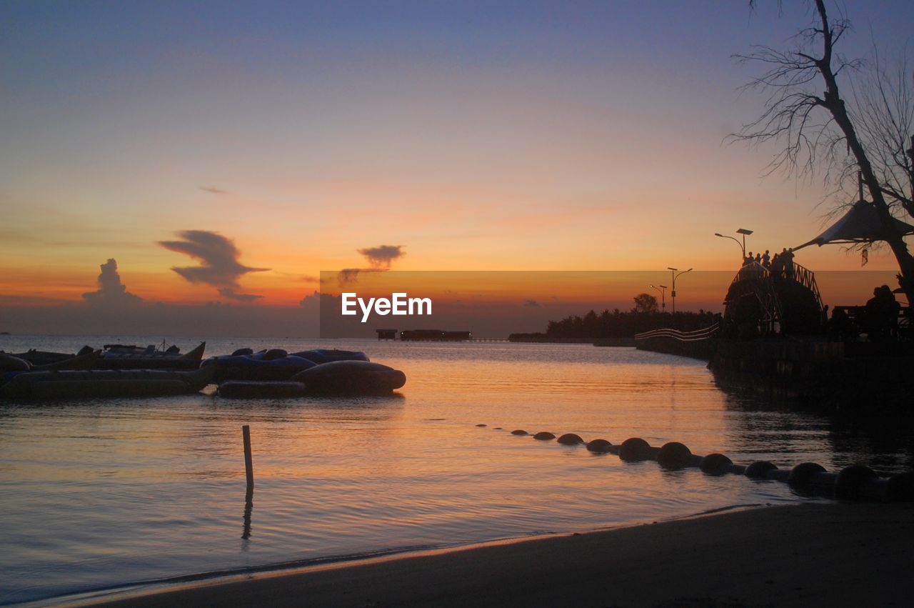 SCENIC VIEW OF SEA AGAINST ORANGE SKY