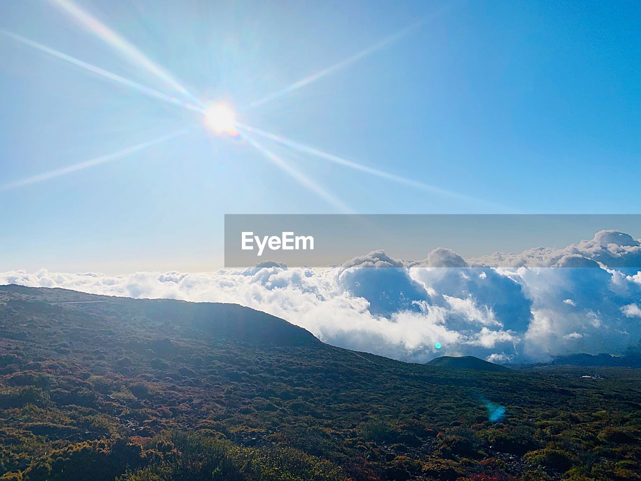 SCENIC VIEW OF MOUNTAINS AGAINST BRIGHT SKY
