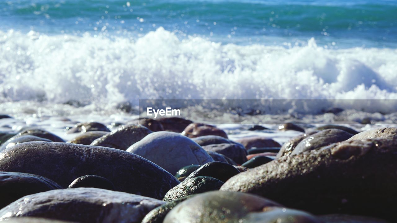 CLOSE-UP OF ROCKS IN SEA