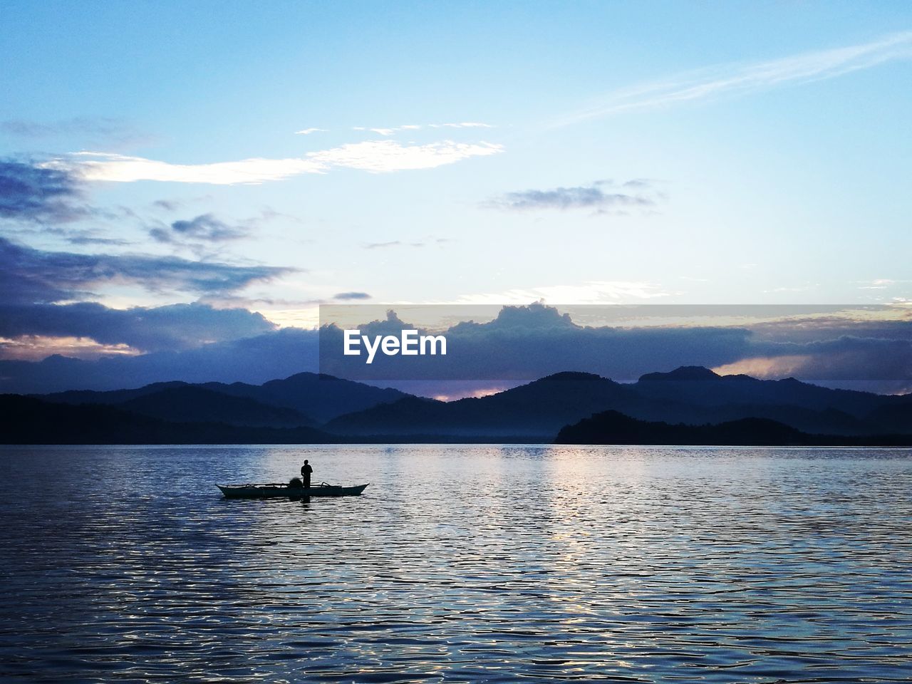 Scenic view of lake against sky during sunset