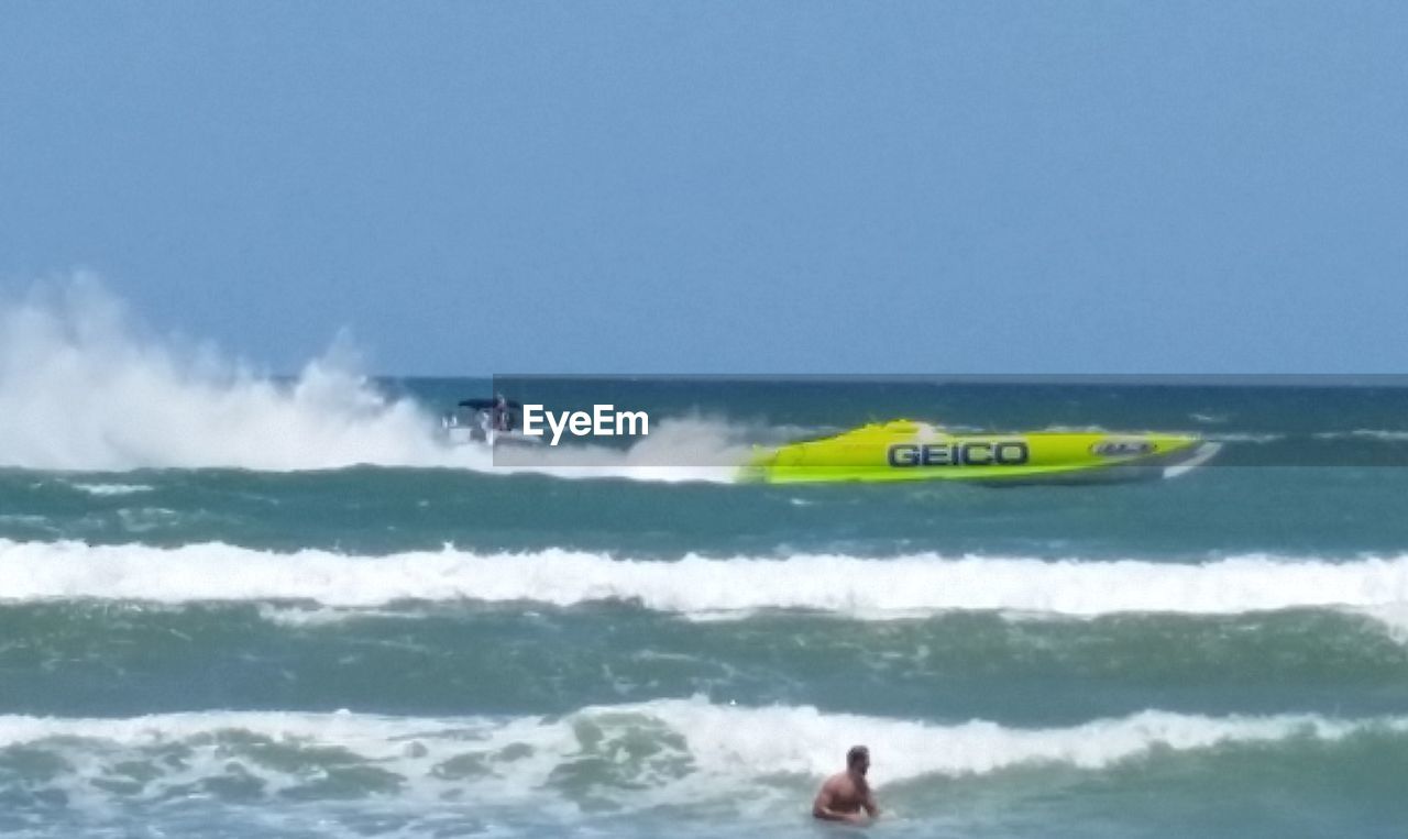 MAN SURFING IN SEA