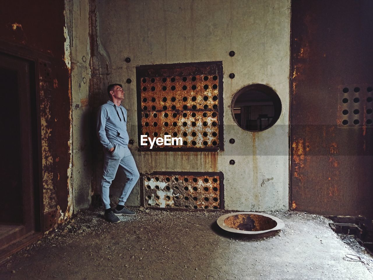 Portrait of man standing by wall