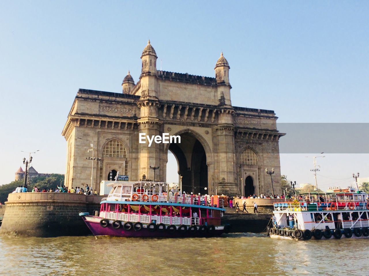 View of boats in sea gateway to india against sky