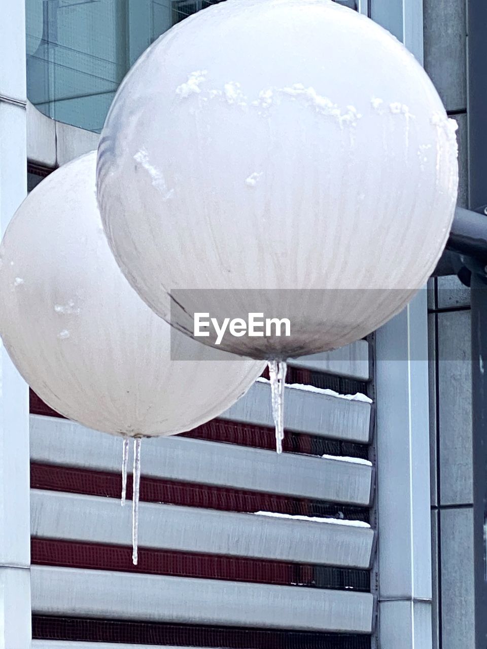 LOW ANGLE VIEW OF WHITE UMBRELLA ON TABLE BY WINDOW