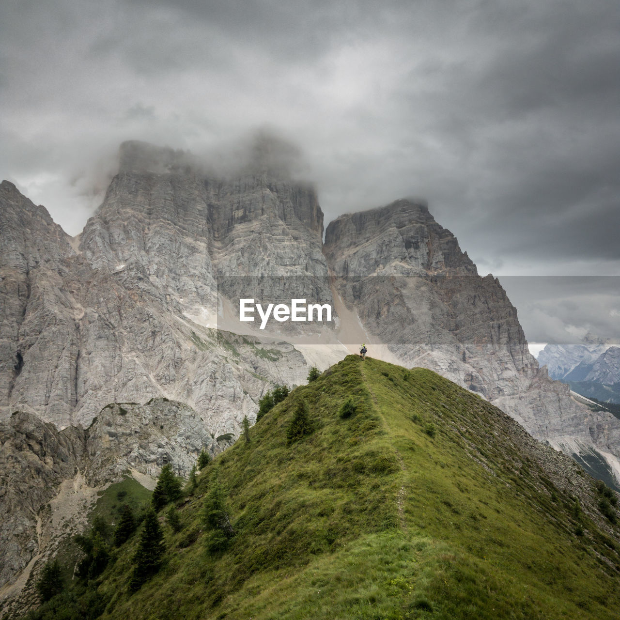 Scenic view of dolomites mountains against cloudy sky