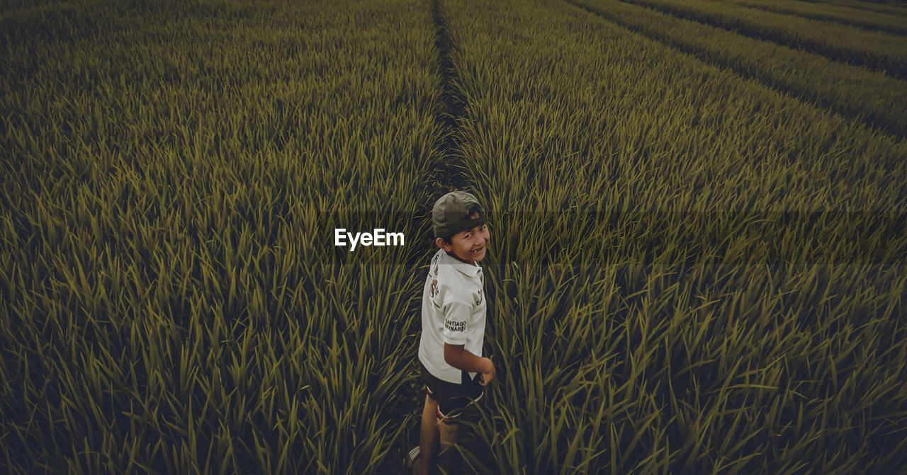 FULL LENGTH OF MAN STANDING IN FARM