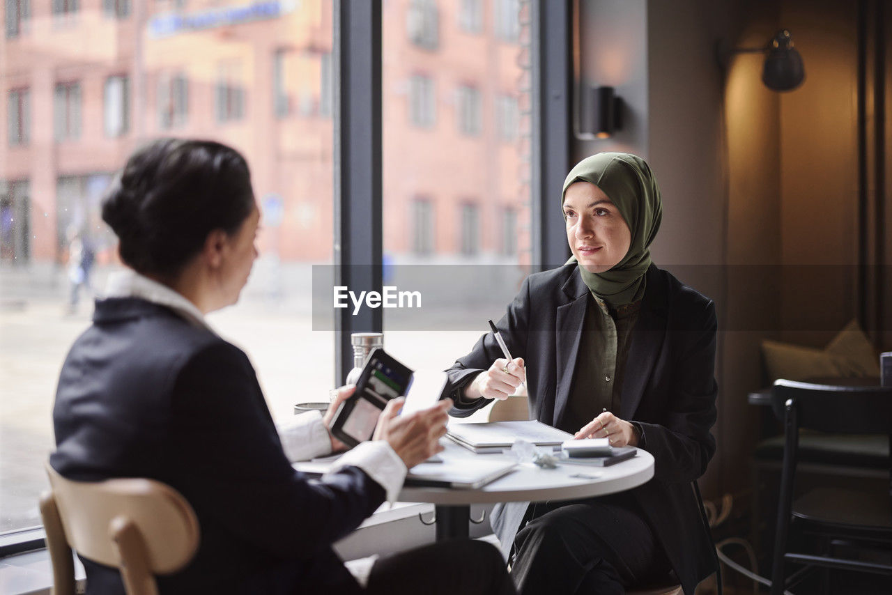 Two businesswomen sitting in cafe