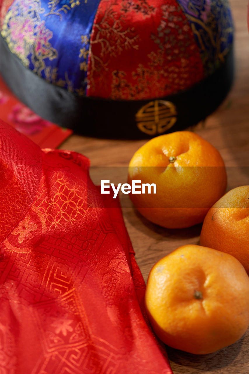 Mandarine oranges and cheongsam with hat