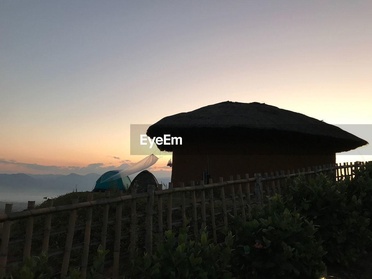 SCENIC VIEW OF FARM AGAINST SKY DURING SUNSET