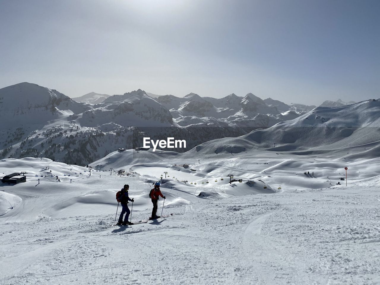 People on snowcapped mountain against sky