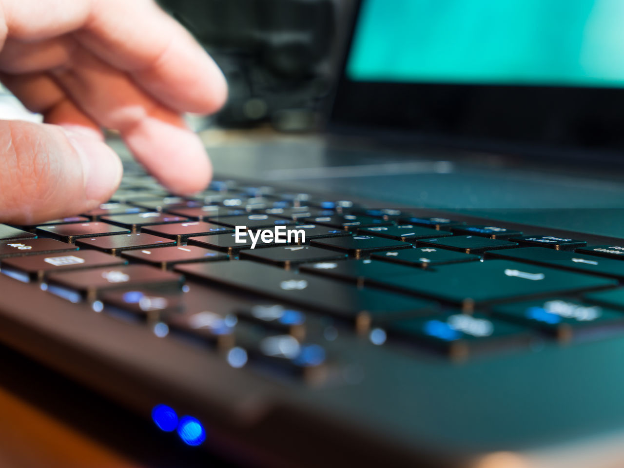 Close-up of finger touching keyboard