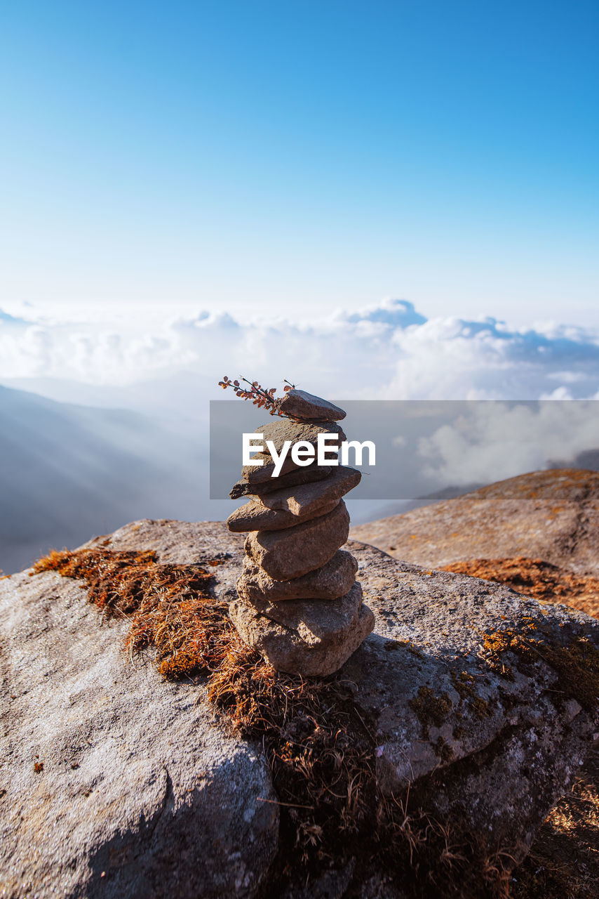 Stack of rocks on a hill against sky