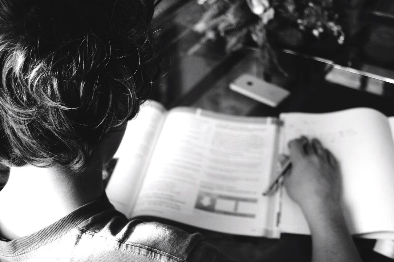 WOMAN HOLDING BOOK WITH TEXT