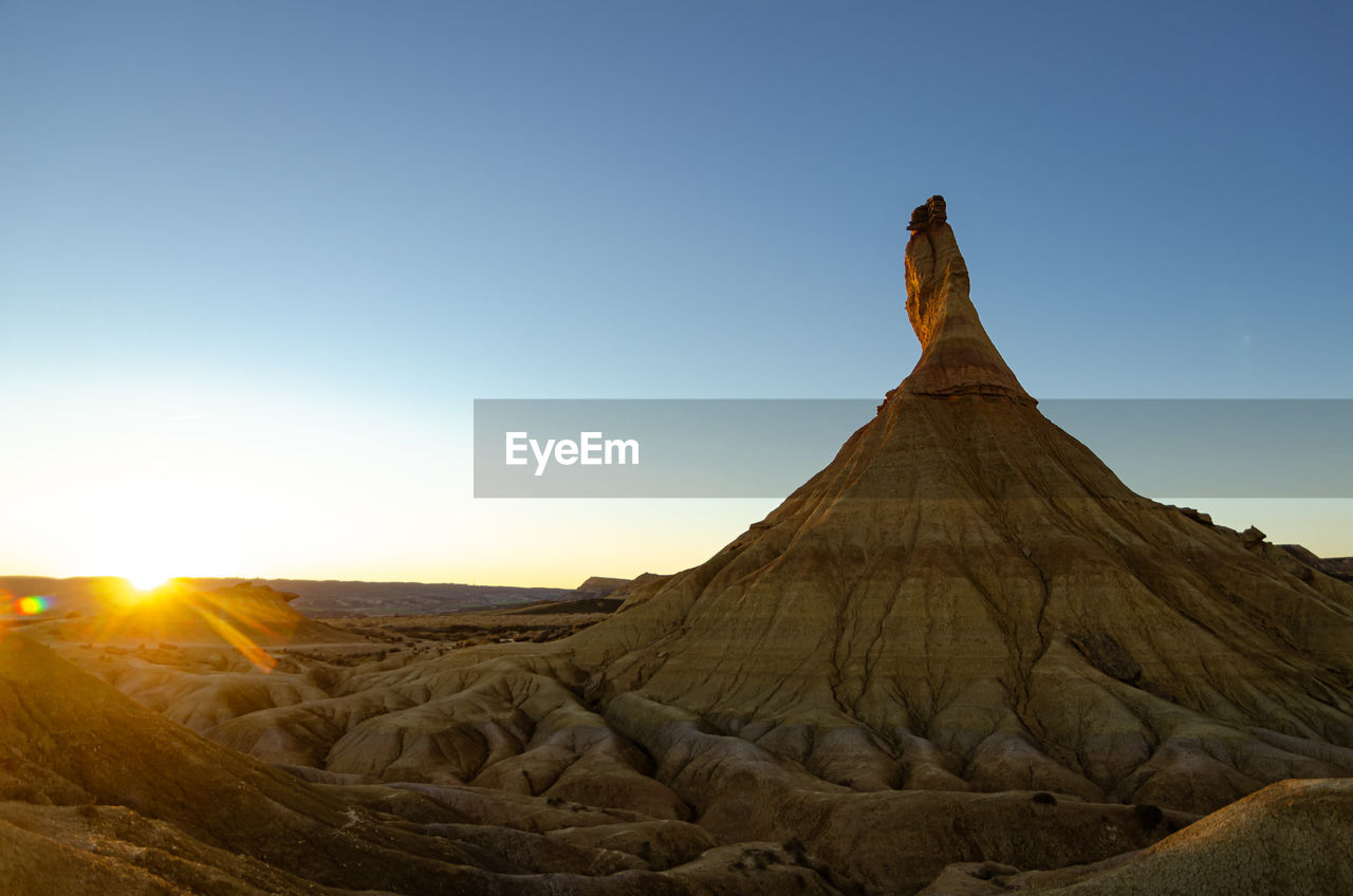 Scenic view of land against clear sky during sunset. bardenas reales, spain