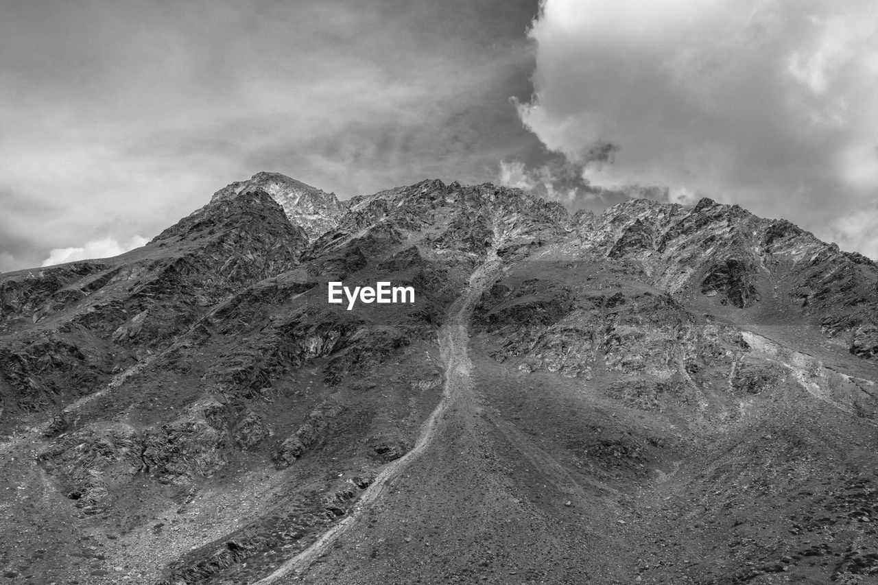 mountain, cloud, environment, landscape, sky, black and white, scenics - nature, beauty in nature, monochrome, nature, monochrome photography, land, volcano, no people, geology, non-urban scene, mountain range, outdoors, day, smoke, extreme terrain, travel, rock, physical geography, travel destinations, accidents and disasters, volcanic landscape, dramatic landscape, mountain peak, ridge, tranquility